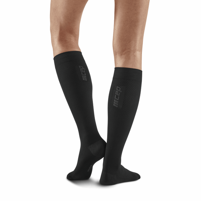 Black CEP Allday Tall Compression Socks for women, shown on a model, featuring a snug fit and durable fabric for support and comfort.