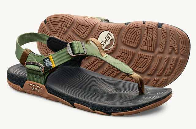 Lems Switchback Sandal shoes with tan straps and cactus green sole, shown from a 3/4 angle.