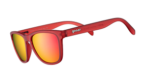 GOODR Phoenix sunglasses with transparent frame and colorful lens, shown at a Bloody Mary bar setting.