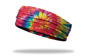 Junk Brands Big Bang headband with colorful striped design, wide athletic headband for active wear and head coverage.