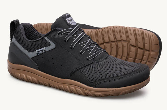 Lems Primal Zen unisex shoes with flexible design and sleek black upper, shown from a side view in the Cobra-3qtrpair image.