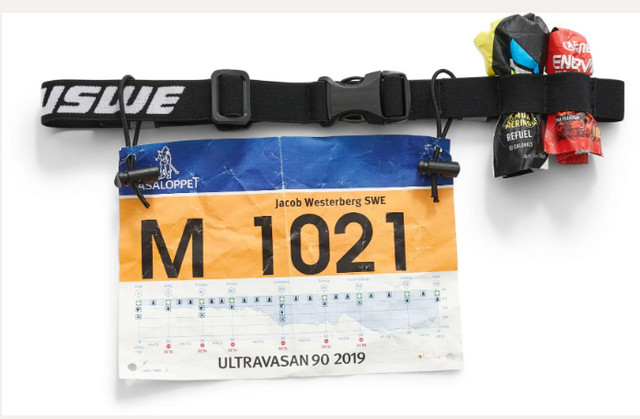 USWE Race ID Belt shown in a screenshot, featuring adjustable straps and multiple storage pouches for outdoor racing and cycling.
