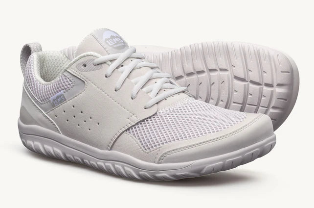 Pair of white Lems Primal Zen unisex shoes showing the side view and breathable mesh upper.